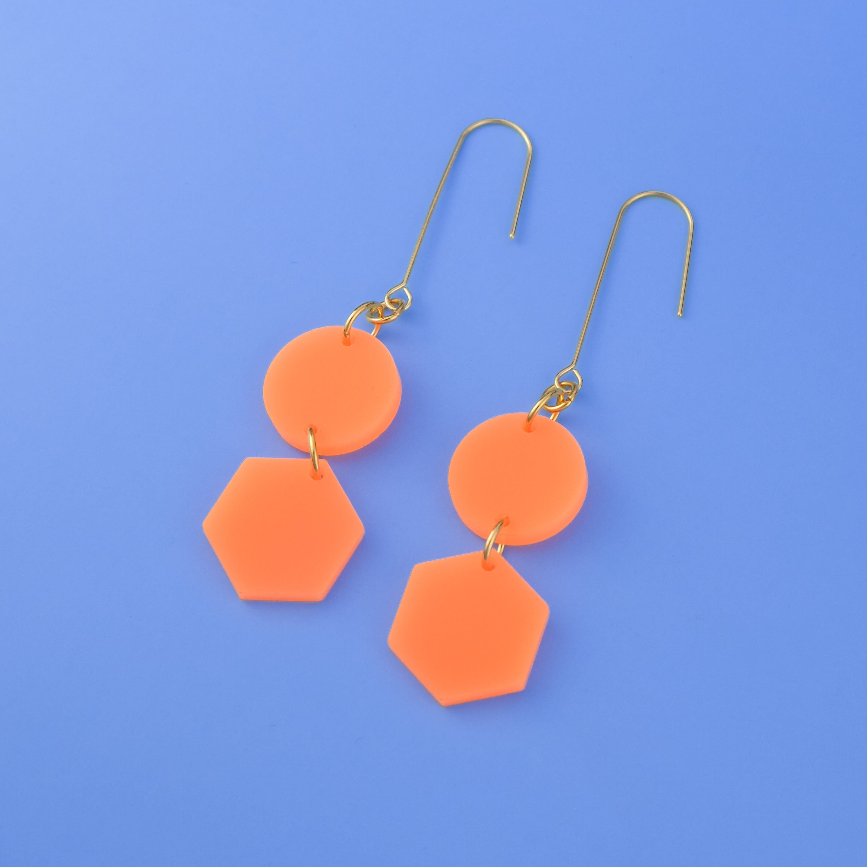 Elegant, elongated and lightweight Belle Dangles geometric dangly earrings in bright neon orange #color_neon-orange