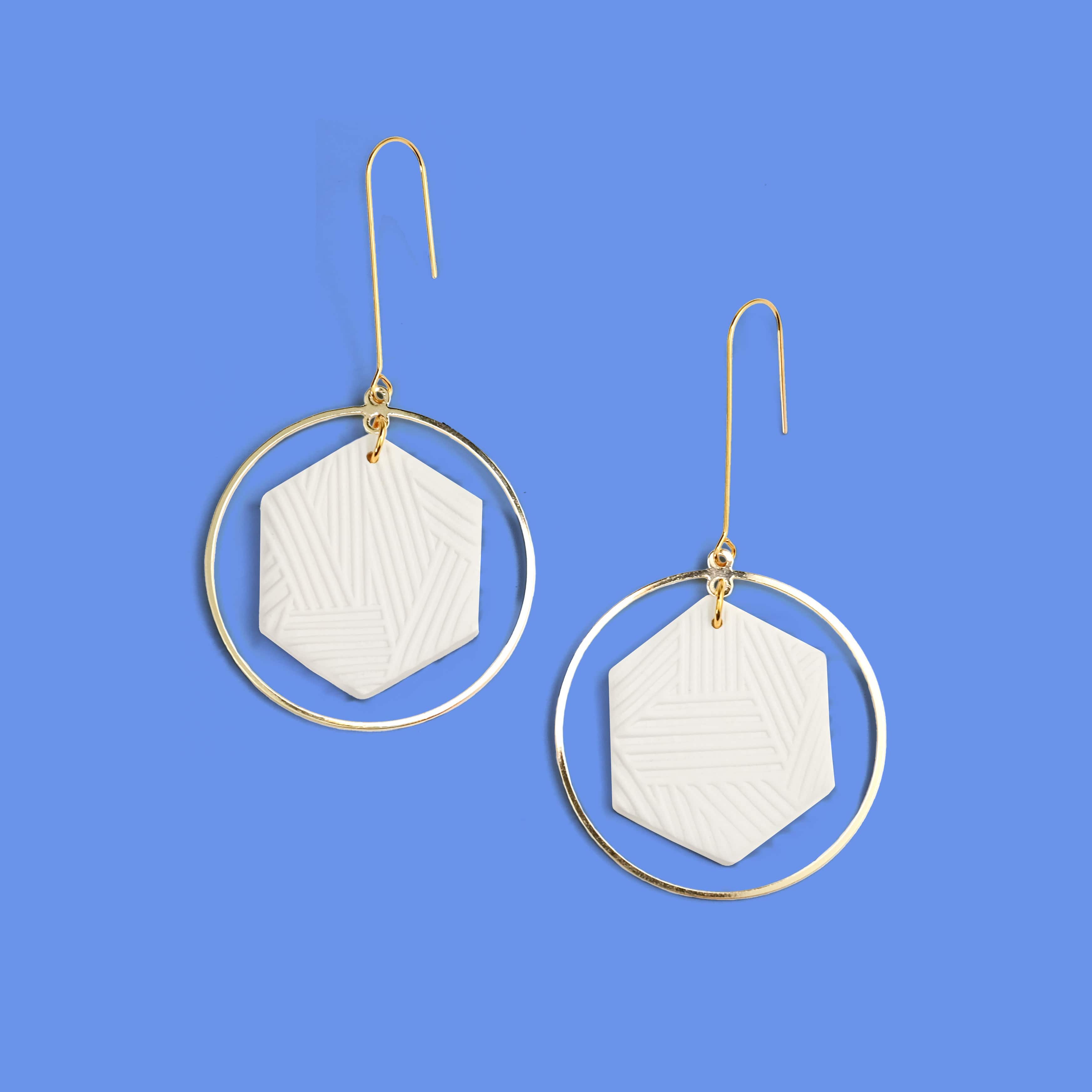 Hex Halo Dangly hexagon shaped elegant and lightweight white and gold earrings #color_white-textured-lines