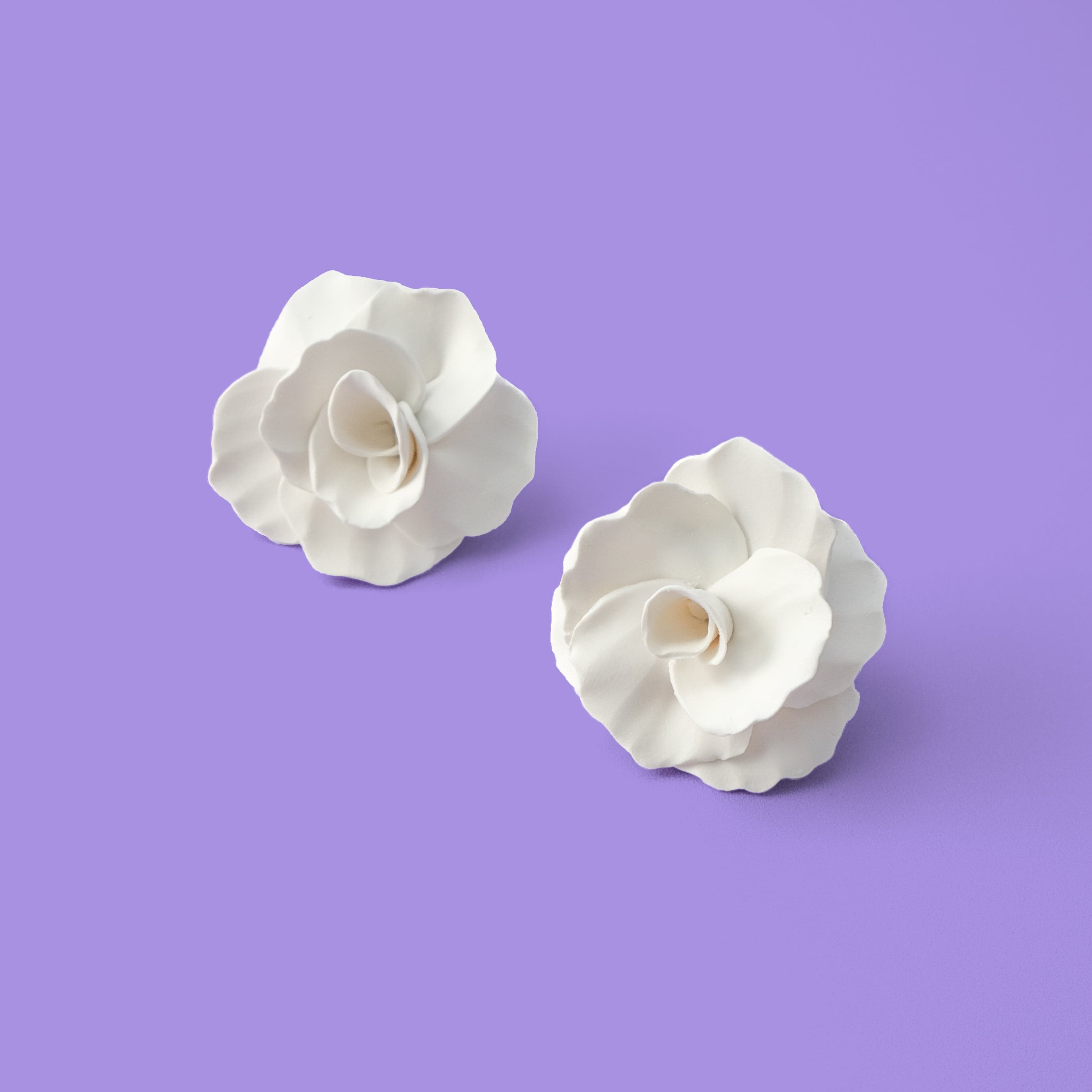 Hand-made statement flower rosette stud earrings in white #color_white